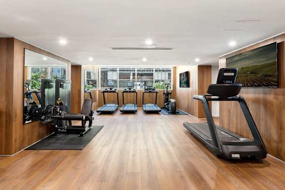Fitness center with treadmills and strength equipment at The Hamilton Apartments, Miami