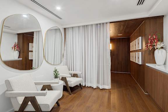 Spa relaxation room with modern chairs and mirrors at The Hamilton Apartments, Miami, FL 33137