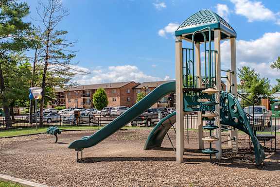 A Playground with a Green Slide at The Manor/The Manor East Apartments, Leesburg, VA