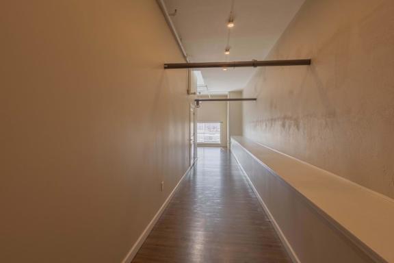 A long hallway with a door at the end.