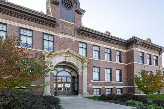 A large brick building with a large arched entrance.