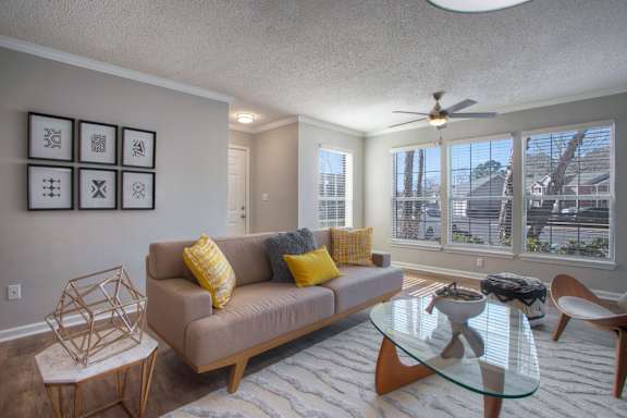 a living room with a couch and a glass coffee table
