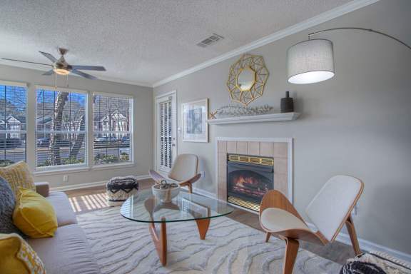a living room with a fireplace and a glass table
