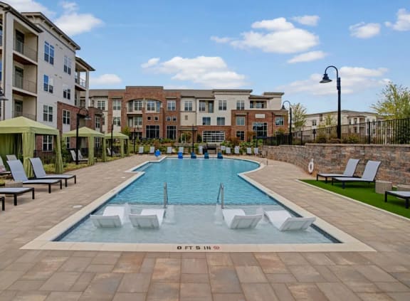 Swimming pool with lounge area and cabanas at Apartments @ Eleven240, 28216