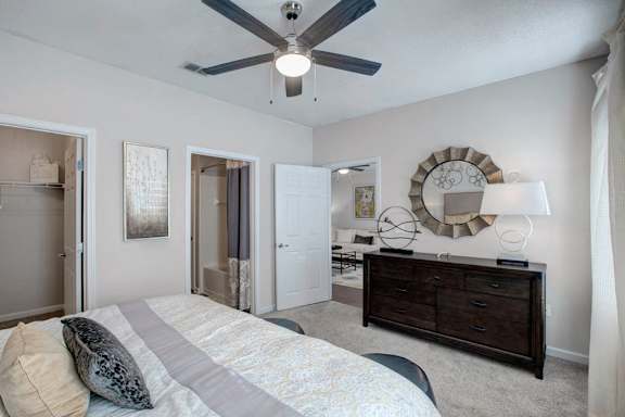 a bedroom with a bed and a ceiling fan