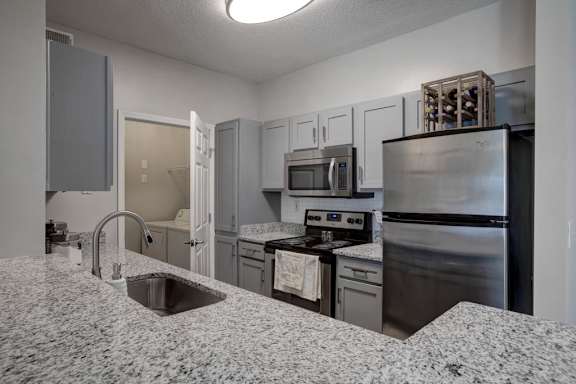 a kitchen with a sink and a refrigerator