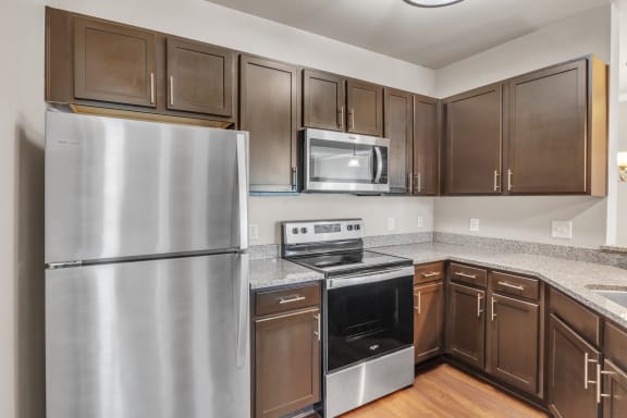 a kitchen with stainless steel appliances and granite counter tops