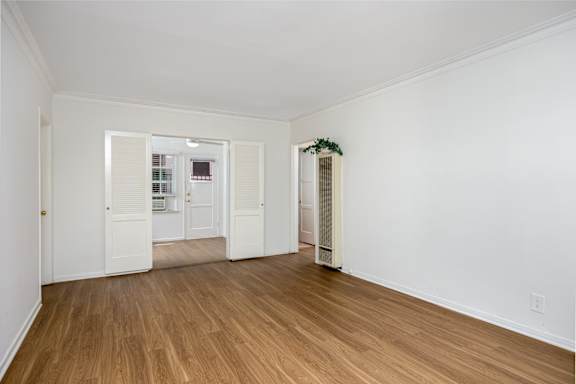 an empty living room with white walls and wood floors