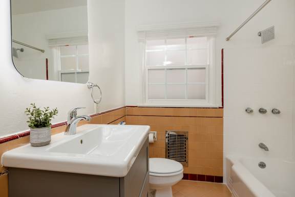 a bathroom with a sink and a toilet and a tub