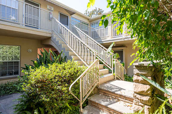 the stairs up to an apartment building with a staircase