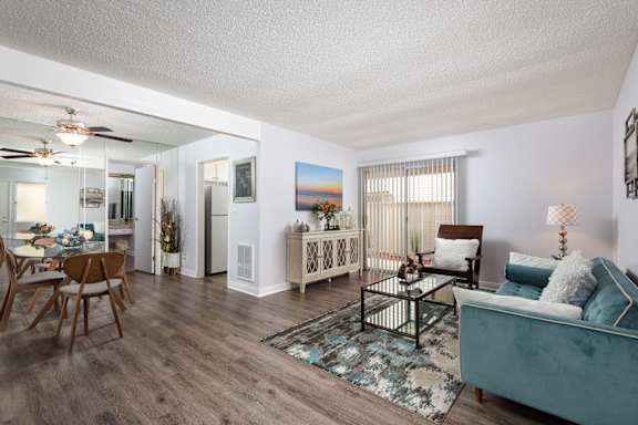 a living room and dining room with a couch and a table