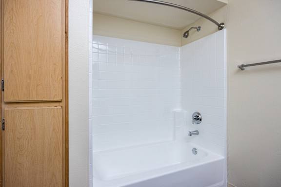 a bathroom with a white tub and a shower