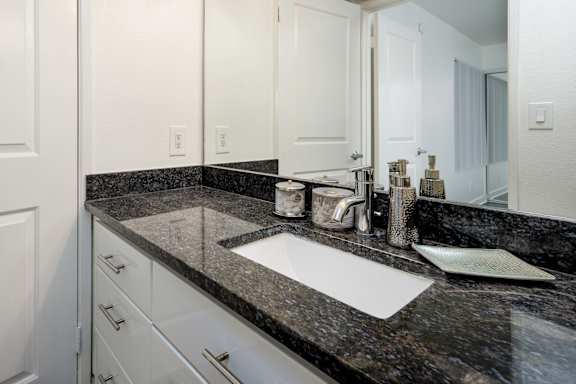 a bathroom with a sink and a mirror
