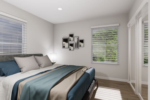 a bedroom with a bed and two windows