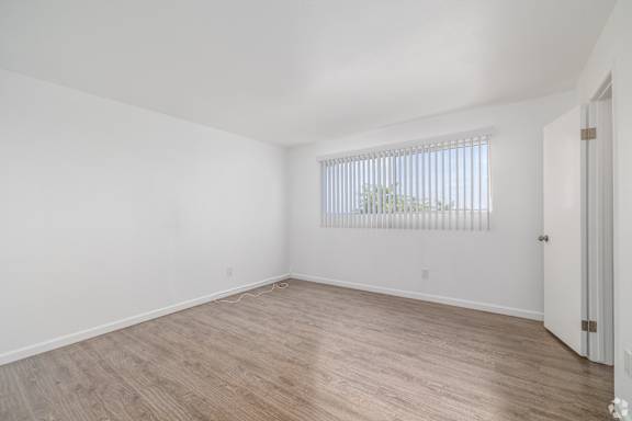 A room with a window and a door.