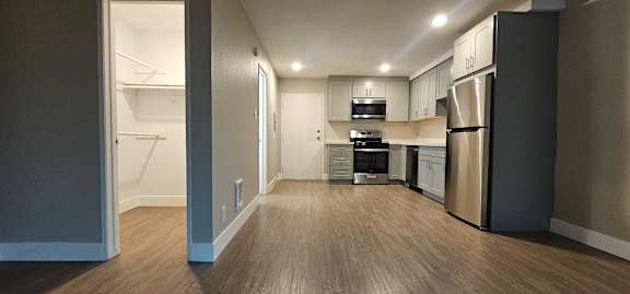 A kitchen with a refrigerator, stove, and oven.