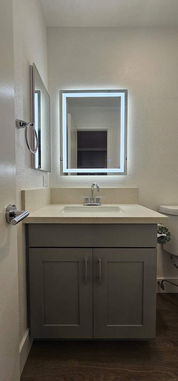 A bathroom with a sink, mirror and medicine cabinet.