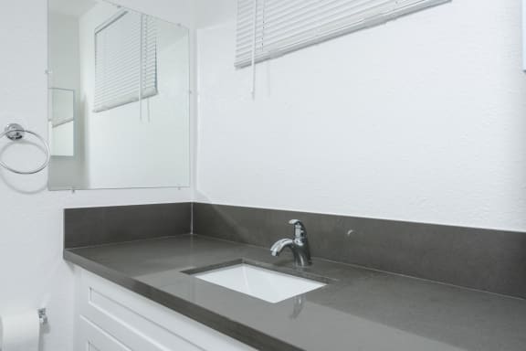 a small bathroom with a sink and a mirror