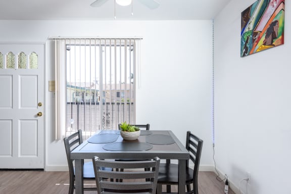 a dining room with a table and chairs and a window