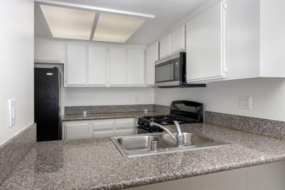 a kitchen with granite counter tops and a sink