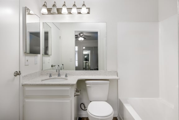 a bathroom with a sink toilet and a mirror