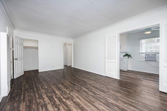 an empty living room with white walls and wood floors