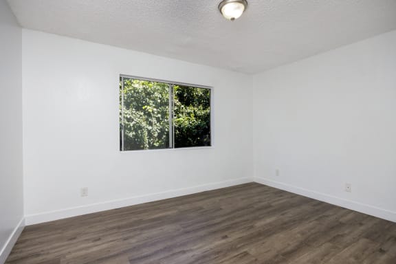 an empty room with white walls and a window