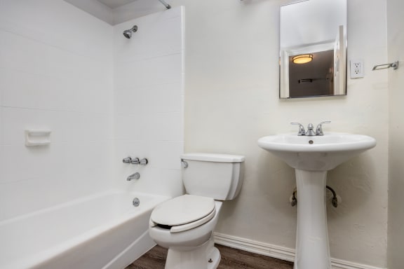 an empty bathroom with a toilet sink and tub