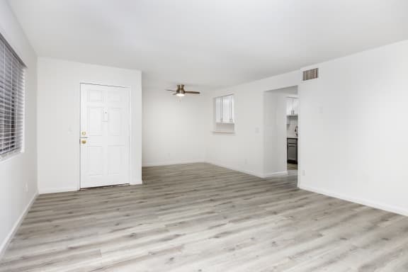 an empty living room with white walls and a white door