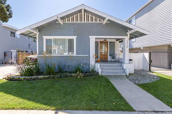 A house with a grey front and a white door.