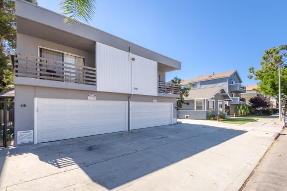 a white house with a garage and a driveway