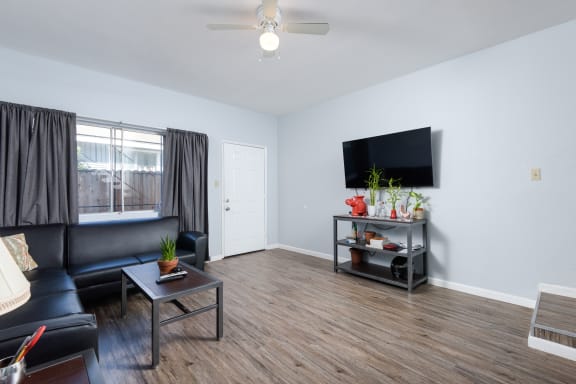 a living room with a leather couch and a tv