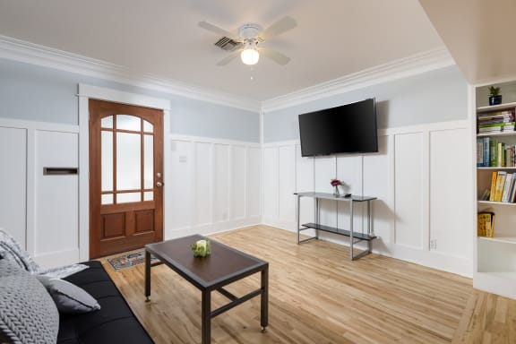 a living room with a couch and a coffee table and a tv