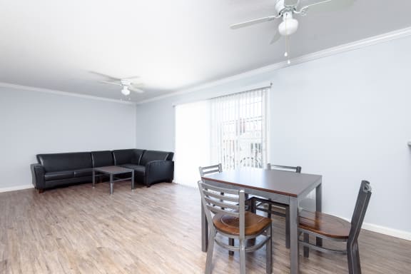 an empty living room with a dining room table and couch