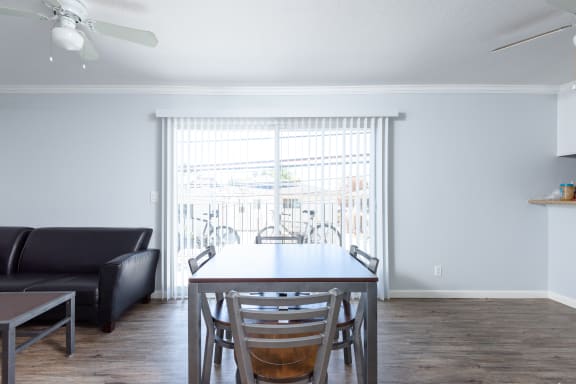 a living room with a dining room table and a large window