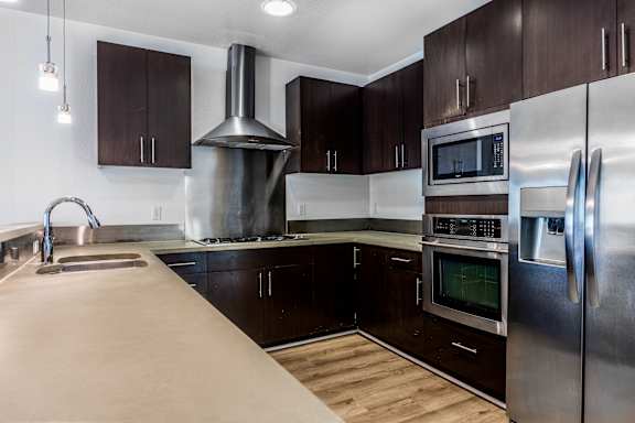 a kitchen with stainless steel appliances and wooden cabinets