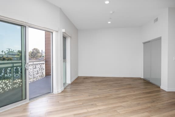 a living room with sliding glass doors and a balcony