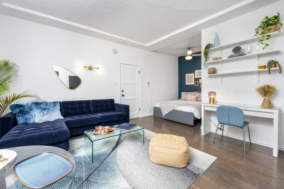 a living room with a couch and a table and a bed