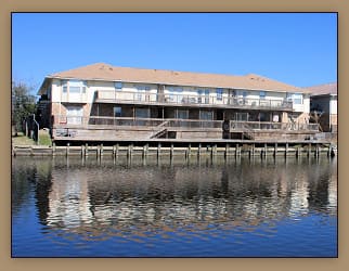 A building is situated on a dock over water.