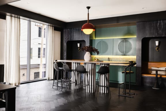 a dining room with a table and chairs and a large window