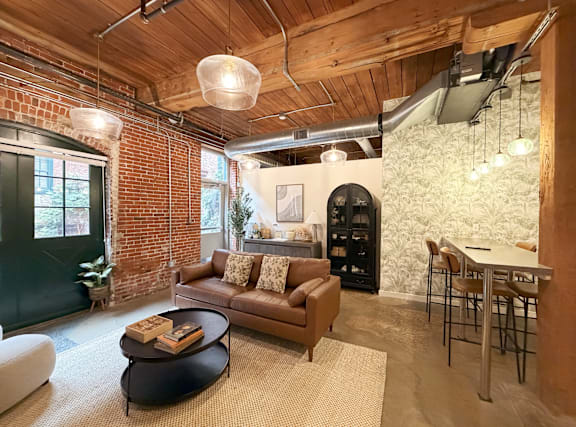 A living room with a brown couch and a coffee table.
