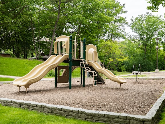 a playground with two slides in a park