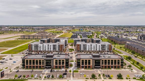 a view of the courtyard of a building with tables and chairs at EagleRidge Plaza Residences, Fargo, ND, 58104