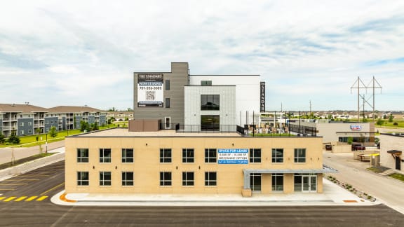 a large building with a blue sky in the background at The Standard on 32nd, West Fargo, ND