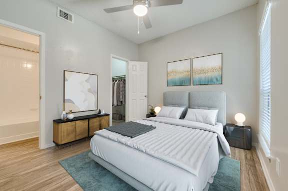 a bedroom with a large bed and a ceiling fan