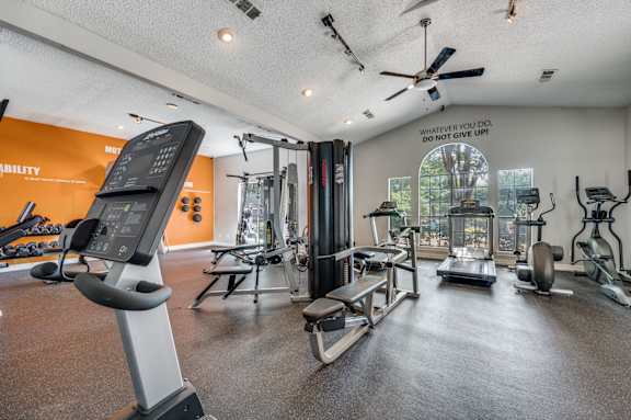spacious gym with cardio machines and weights at the everyday gardener apartments