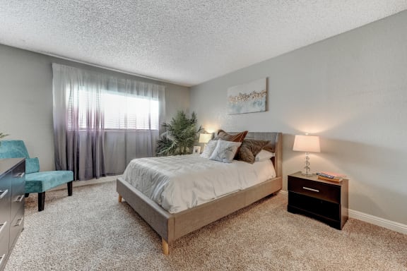 a bedroom with a bed and a dresser and a window