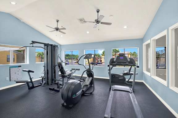 A spacious home gym with a variety of exercise equipment. at Village Park, Orlando, FL, 32808