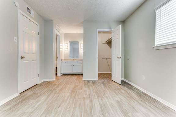 an empty room with a bathroom and a closet