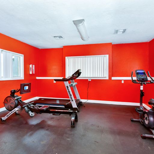 A room with a rowing machine and a stationary bike  at Village Springs in Orlando FL.